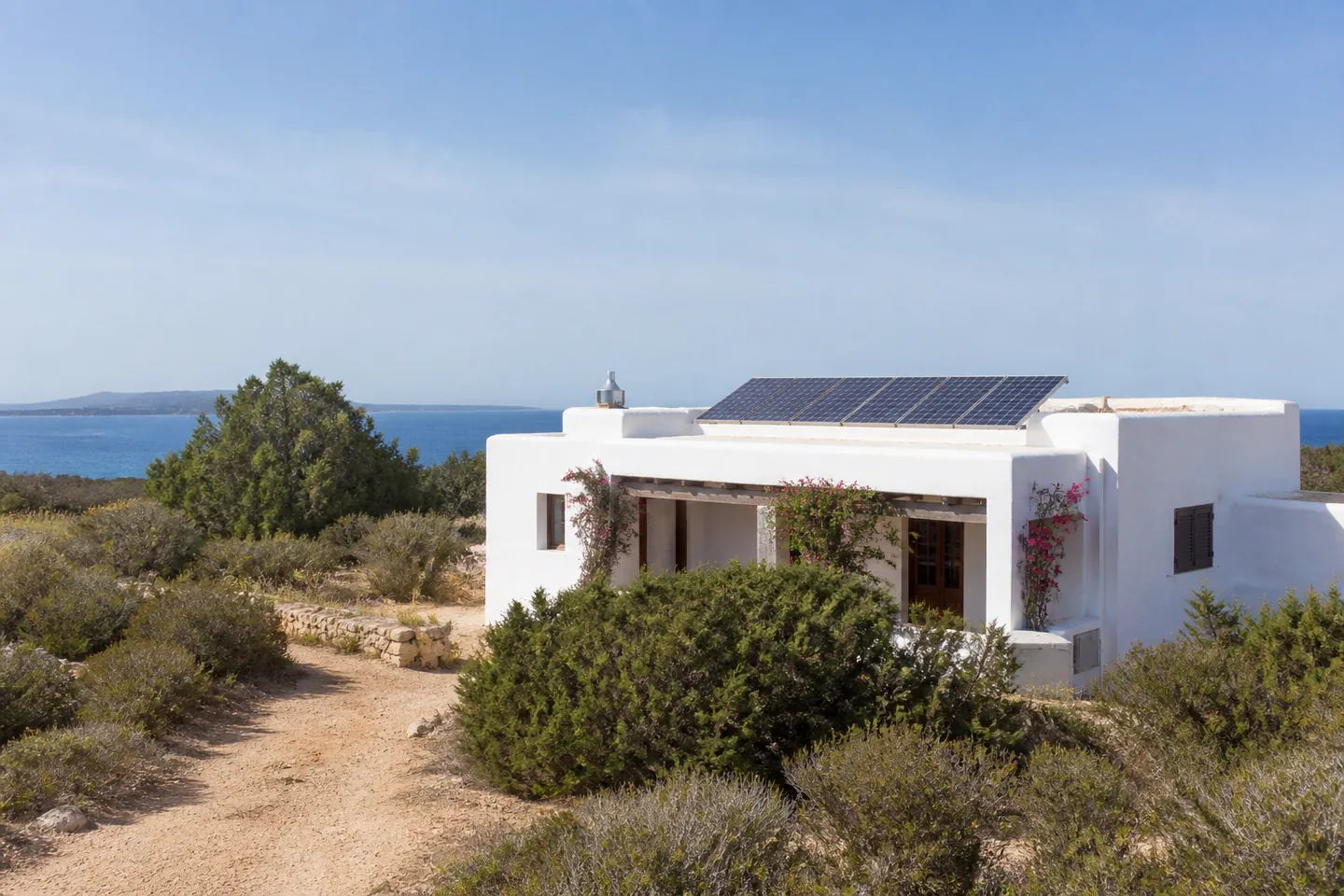 Whitewashed Formentera home with rooftop solar panels